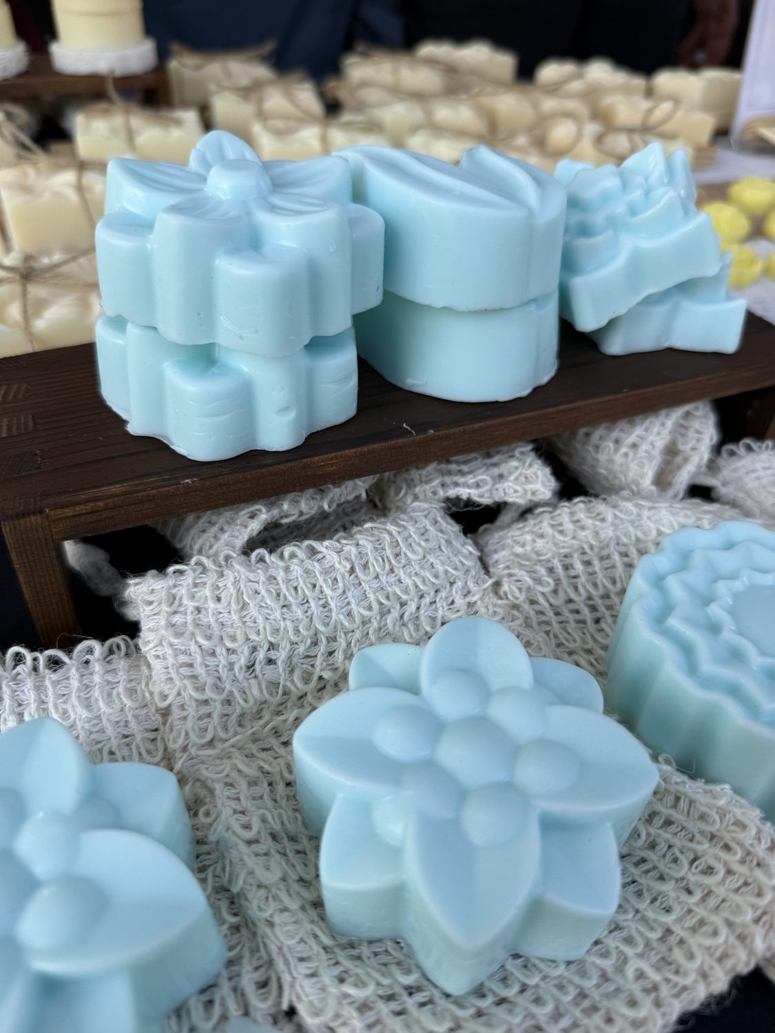 Pale blue soaps molded into floral and succulent shapes